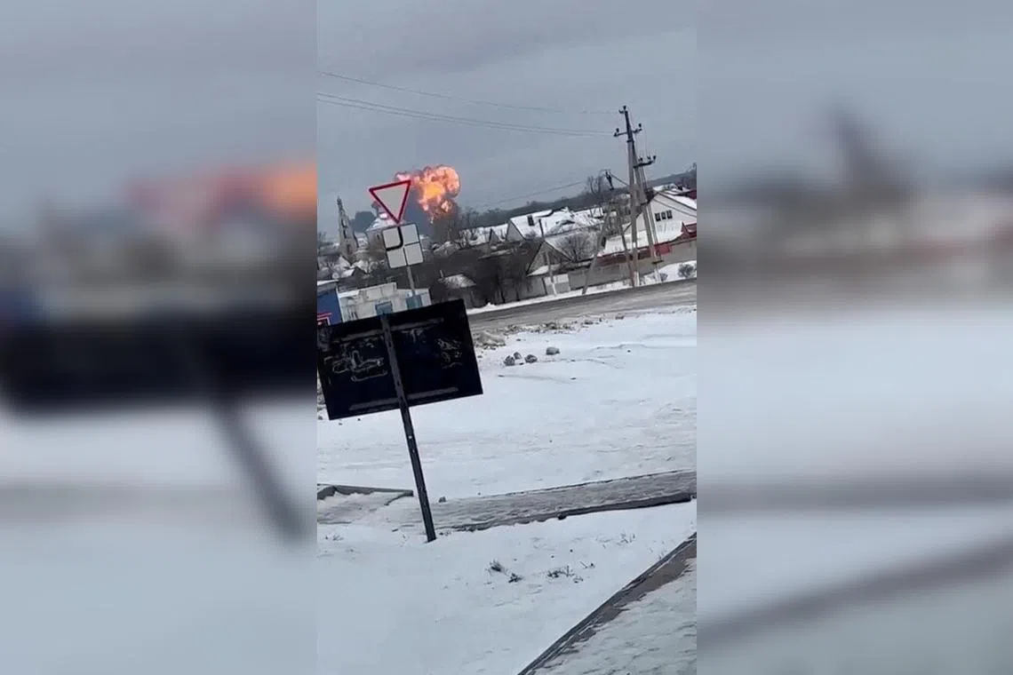 A Russian military transport plane crashes near Yablonovo, in Russia's Belgorod region, in a screen grab from a social media video.