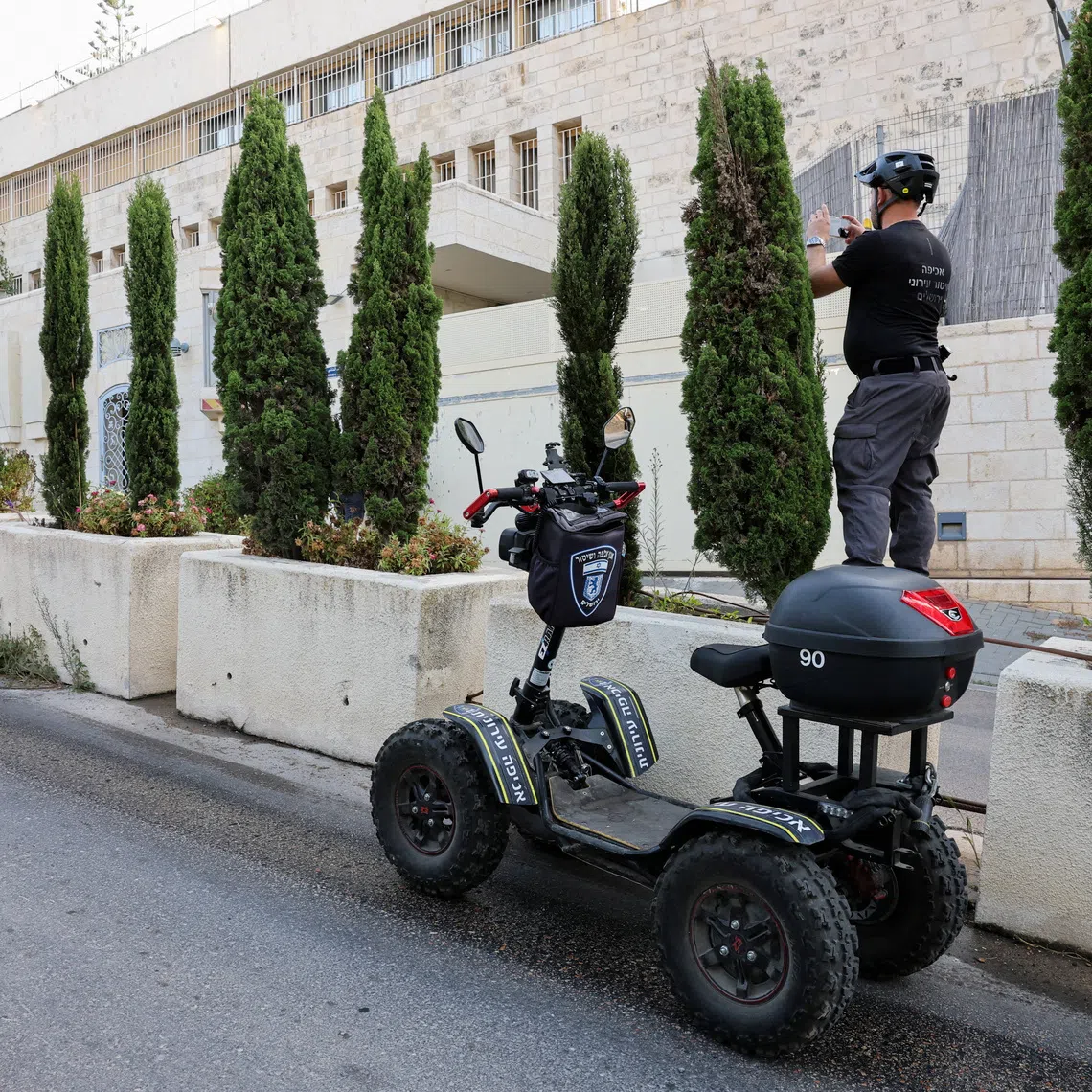 A member of Jerusalem Munipality photographs the British consulate on the deadline set by Israel for its closure, following trade sanctions imposed by British Prime Minister Andy Burnham on Israeli settlements in the occupied West Bank, in East Jerusalem, October 8, 2026. REUTERS/Ammar Awad