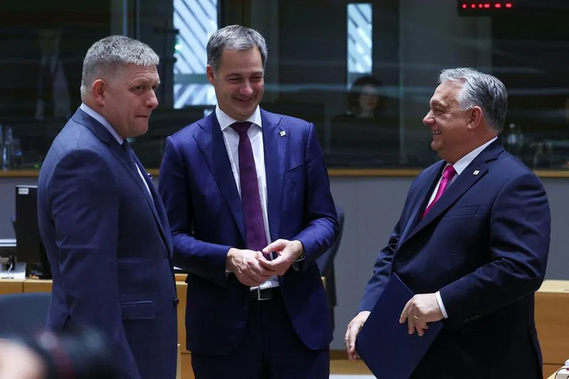 Slovakia's Prime Minister Robert Fico, Belgian Prime Minister Alexander De Croo and Hungarian Prime Minister Viktor Orban speak during the European Union leaders summit, in Brussels, Belgium October 26, 2023. REUTERS/Yves Herman