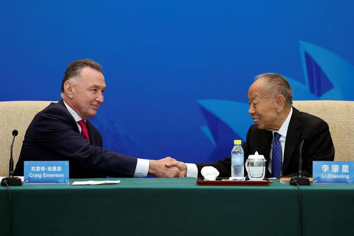 Australia's former trade minister Craig Emerson and China's former foreign minister Li Zhaoxing shake hands at the 7th China-Australia High Level Dialogue at the Diaoyutai State Guesthouse in Beijing, China September 7, 2023. REUTERS/Florence Lo/Pool