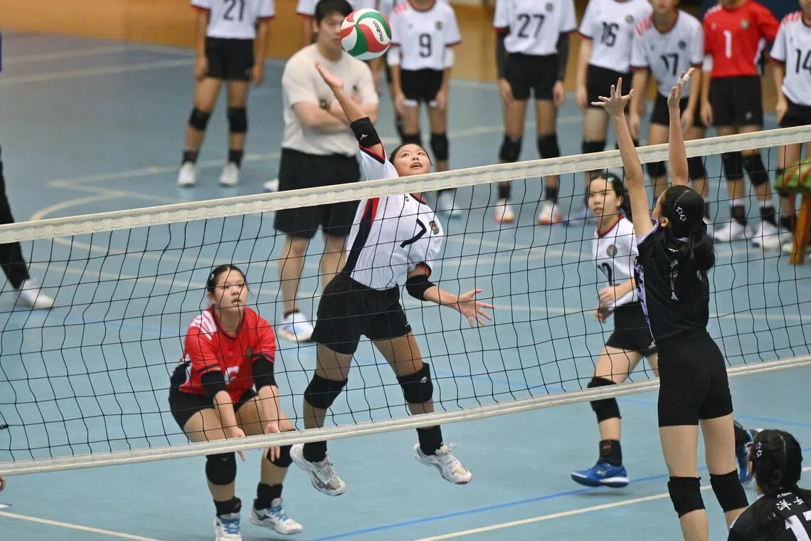 Bukit Panjang Government High School’s captain Brenda Tan (white) spiking the ball against Nanyang Girls’ High School (black) at the National School Games C Div Girls’ volleyball final at Our Tampines Hub on Aug 31.