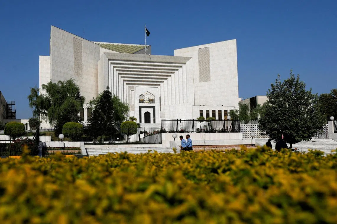 FILE PHOTO: Police officers walk past the Supreme Court of Pakistan building, in Islamabad, Pakistan April 6, 2022. Blasphemy is punishable by death in Pakistan and while no one has ever been executed for it, people have been lynched by outraged mobs after being accused of it.

REUTERS/Akhtar Soomro/File Photo