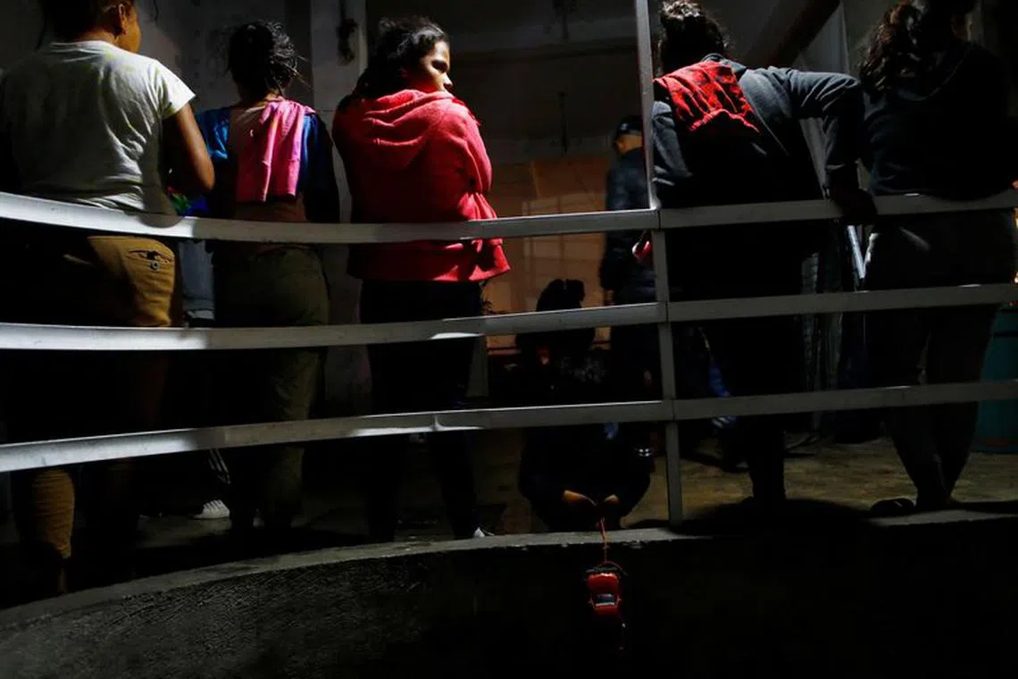 A migrant child plays with a plastic car as fellow migrants wait to enter the bathroom at the historic Our Lady of Solitude church, which has morphed into the city's largest make-shift migrant shelter, with a small tent city clustered around it as most wait to resume their trek north to the U.S. border, in Mexico City, Mexico November 27, 2023. REUTERS/Claudia Daut/File Photo