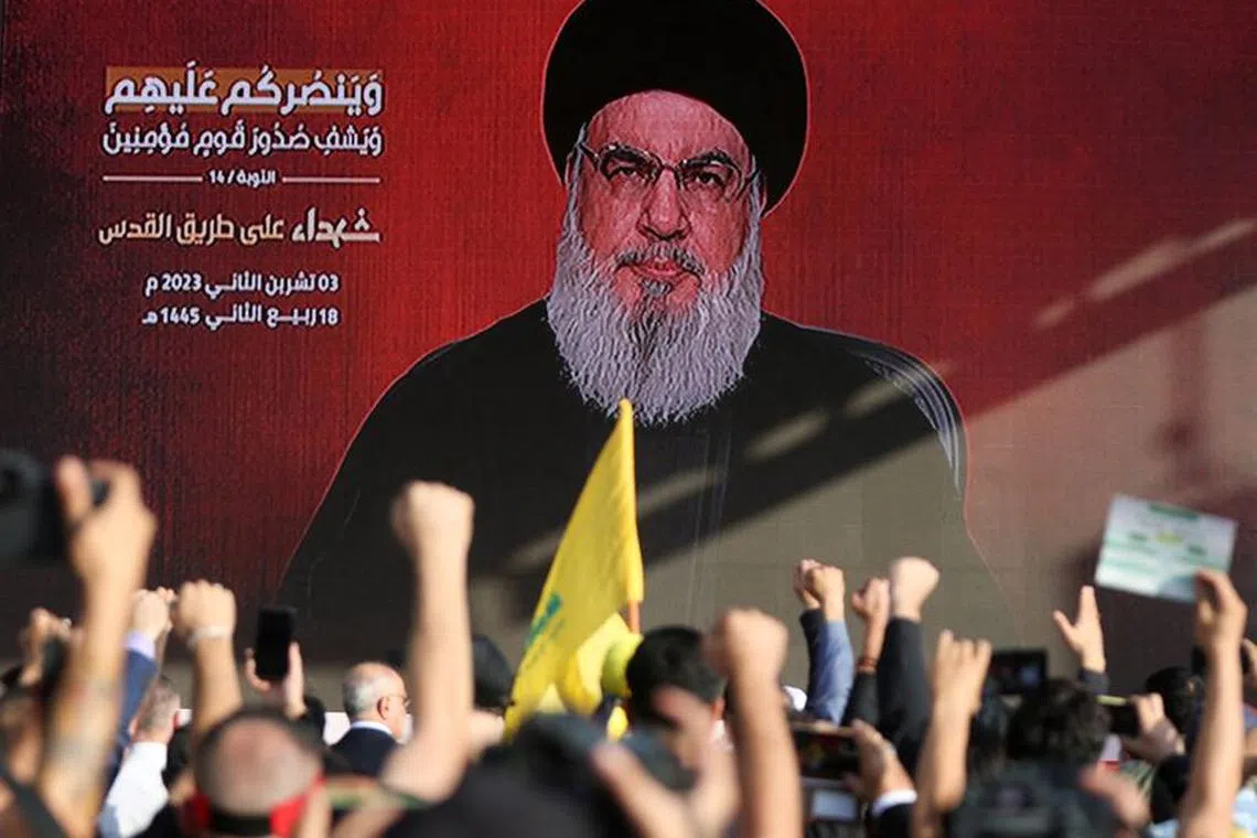 Lebanon's Hezbollah leader Sayyed Hassan Nasrallah appears on a screen as he addresses his supporters during a ceremony to honour fighters killed in the recent escalation with Israel, in Beirut's southern suburbs, Lebanon November 3, 2023. REUTERS/Mohamed Azakir