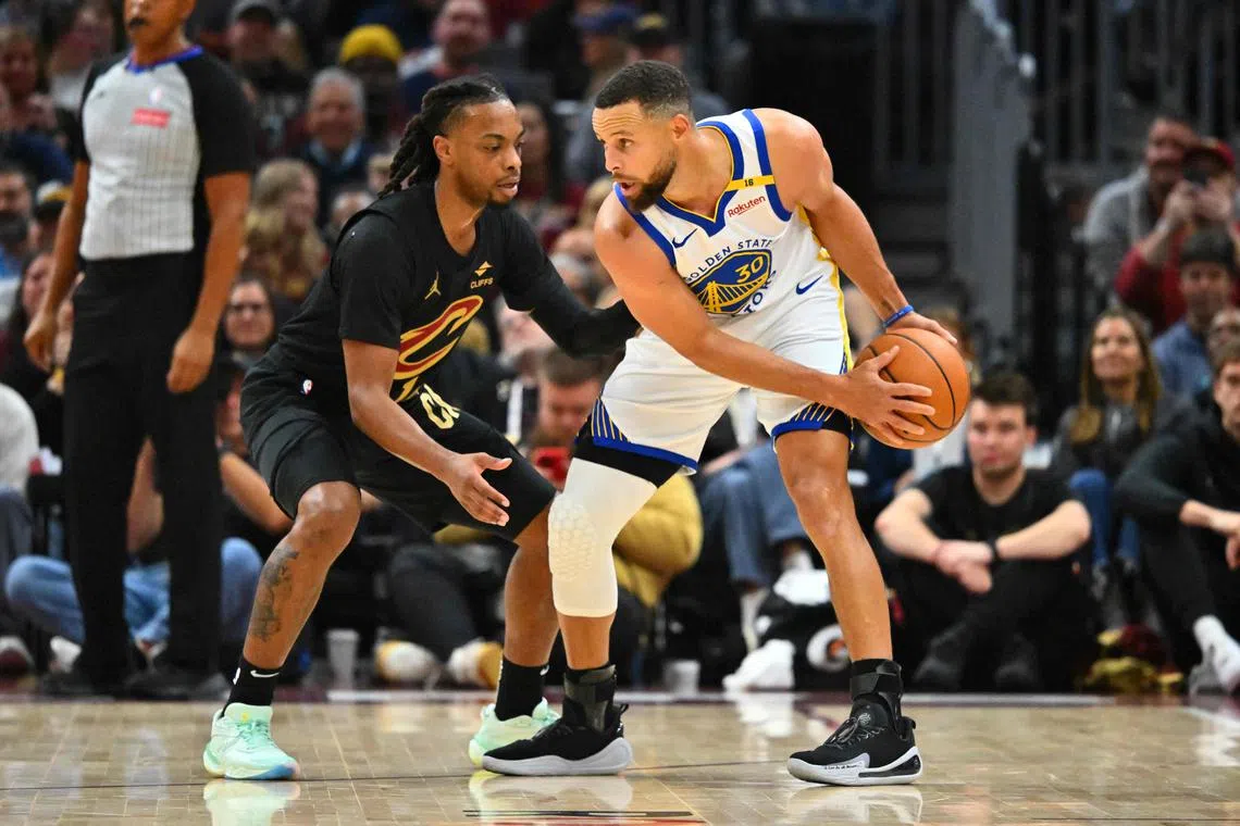 Darius Garland of the Cleveland Cavaliers guards Stephen Curry of the Golden State Warriors during the first quarter at Rocket Mortgage Fieldhouse.