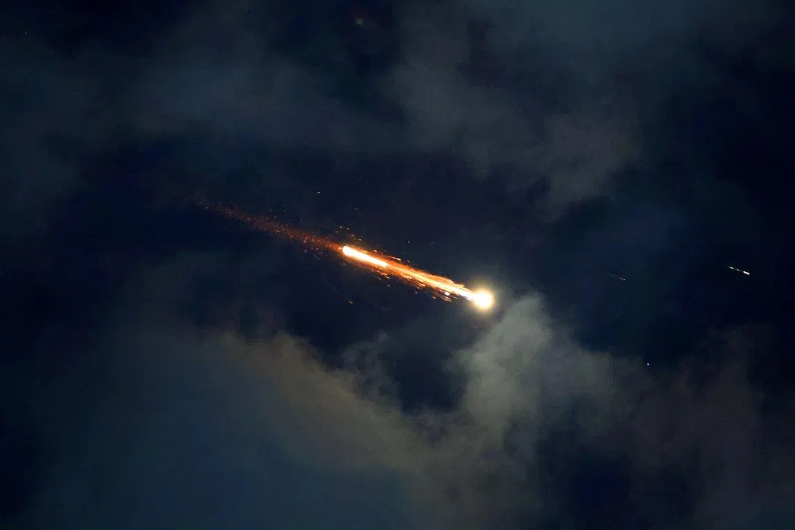 Rocket trails are seen in the sky above the Israeli coastal city of Netanya, amid a fresh barrage of Iranian missile attacks on June 21.