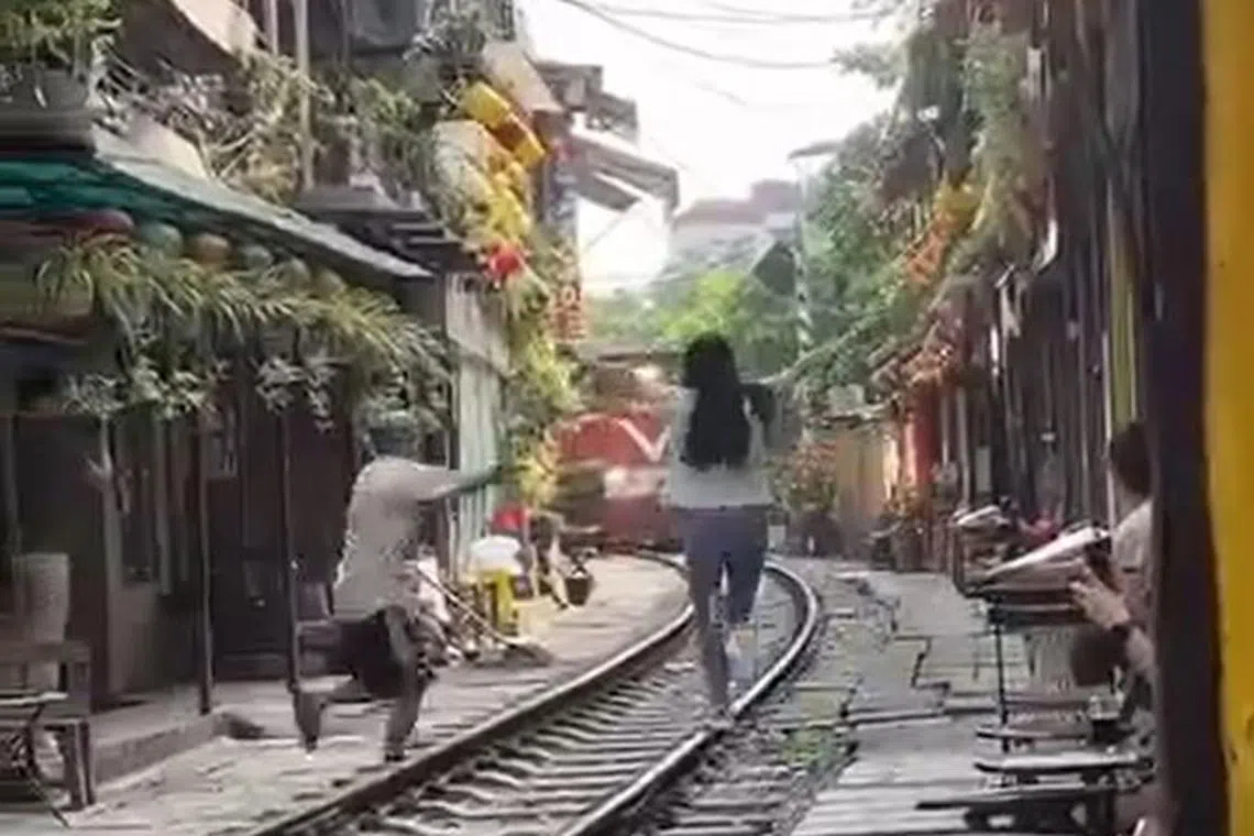 A video posted on Facebook showed a woman coming out onto the track and seemingly pose for a photo as the train approached.