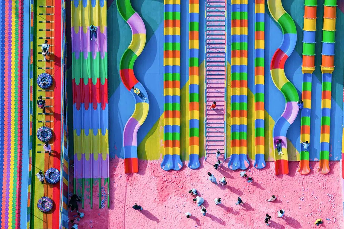 This aerial photo taken on Oct 29, 2023 shows people playing at a playground in China's southwestern Chongqing municipality. 