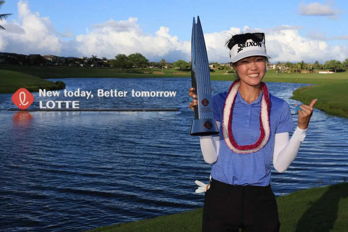 Grace Kim of Australia poses with the Lotte Championship trophy at Hoakalei Country Club.