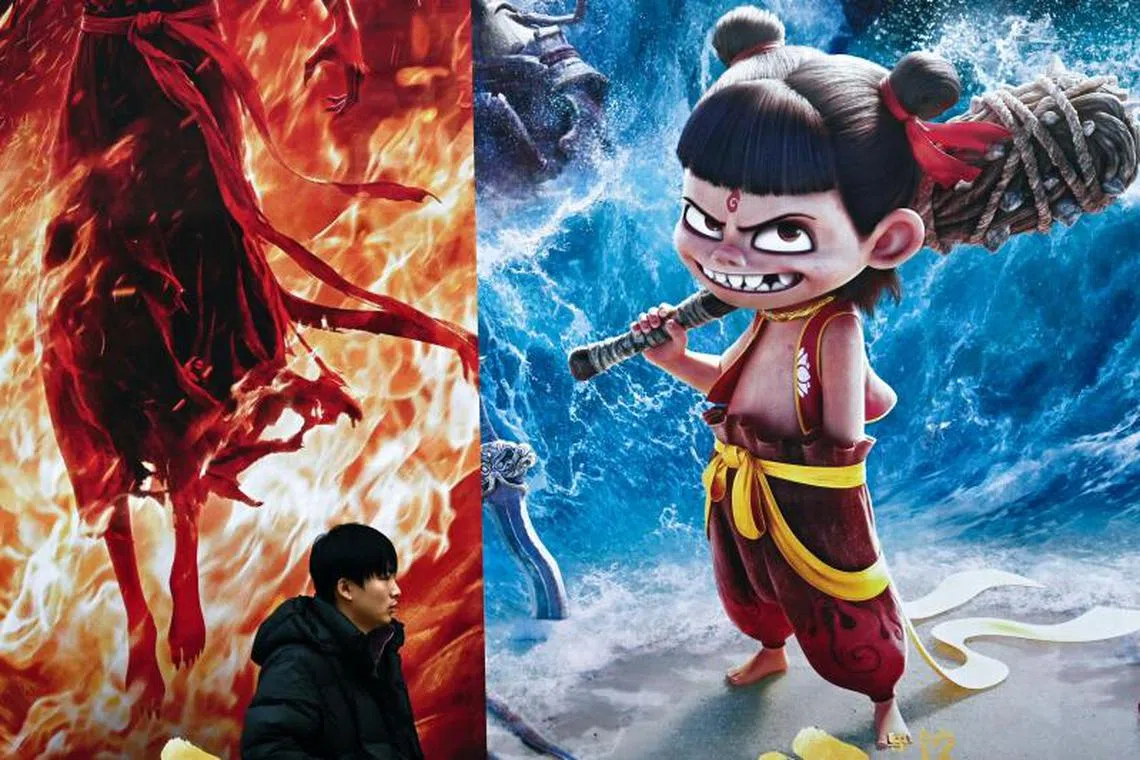 A man (walks past a promotion for the Chinese animated film Ne Zha 2, produced by Enlight Media, outside the production company's headquarters in Beijing on Feb 11, 2025. The movie has now earned over US$1 billion.