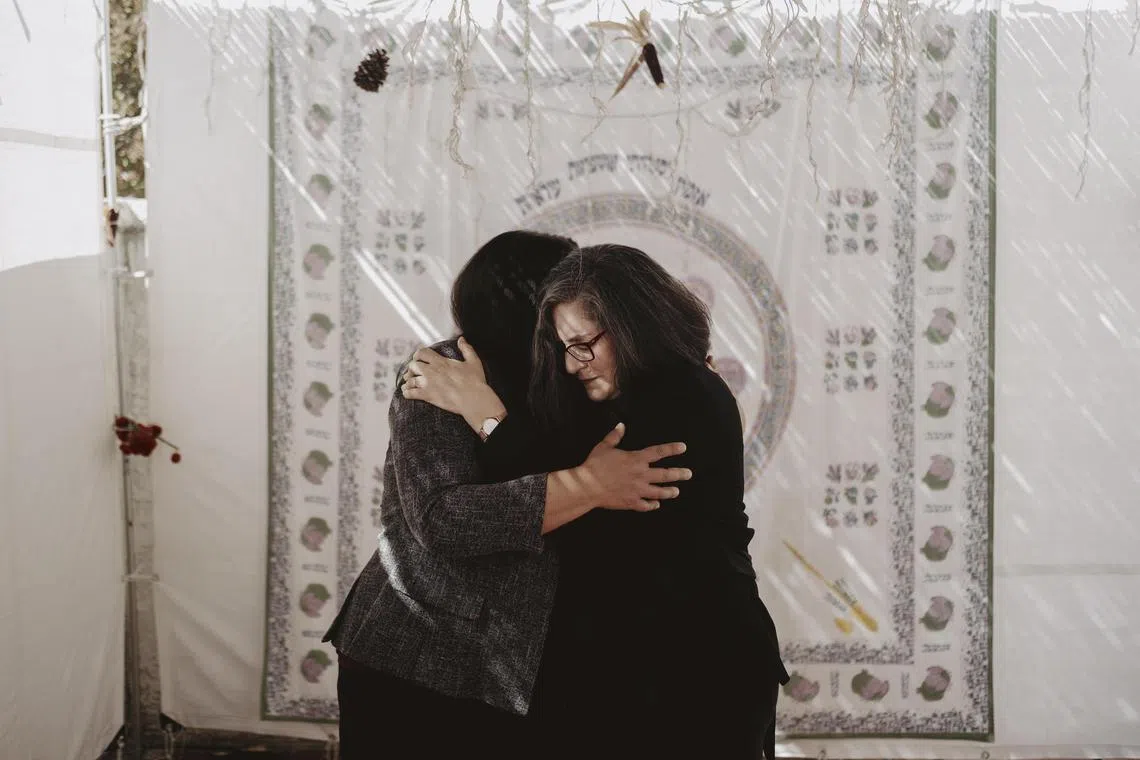 Ms Aziza Hasan (left), a devout Muslim with family ties to Palestine who runs NewGround, embraces Ms Andrea Hodos, a devout Jew and former resident of Israel who is associate director of the nonprofit fellowship programme that brings together members of the two faiths. 