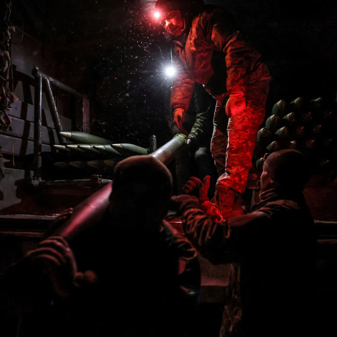 A Ukrainian soldier loads missiles for a BM-21 Grad multiple-launch rocket system as they prepare to fire toward Russian troops, near the town of Chasiv Yar in Donetsk region, Ukraine.