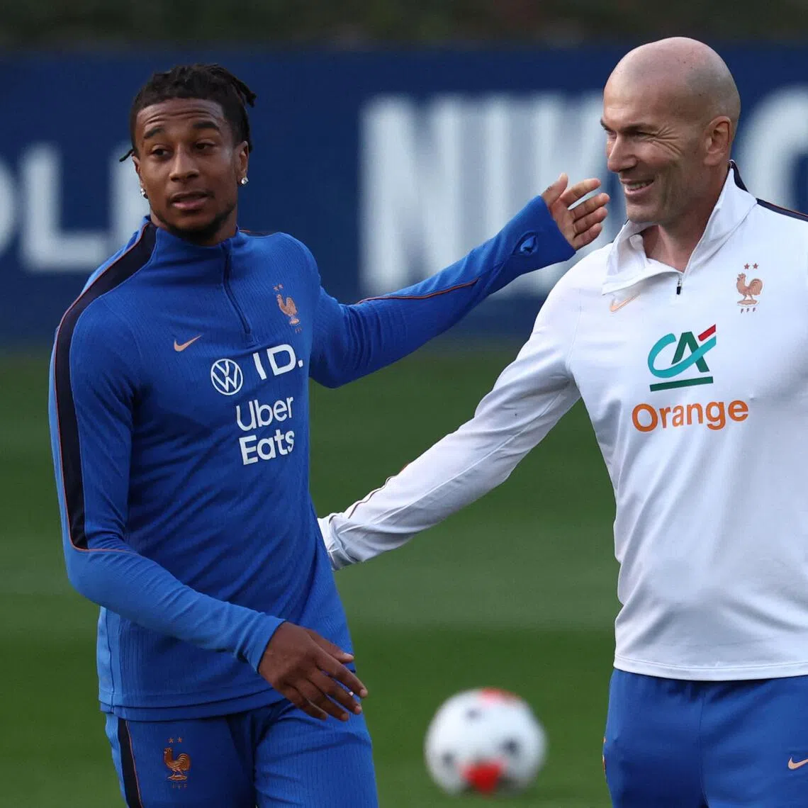 France’s coach Zinedine Zidane (right) and Michael Olise during a training session in Clairefontaine-en-Yvelines, outside Paris, on Sept 21.
