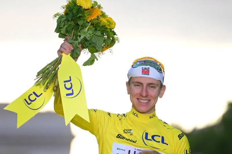 UAE Team Emirates XRG’s Tadej Pogacar celebrates on the podium while wearing the yellow jersey after winning the 21st and final stage of Tour de France on July 26.