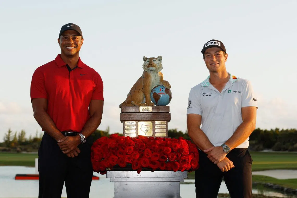 Viktor Hovland of Norway celebrates with the trophy and host Tiger Woods after winning the Hero World Challenge on Sunday.