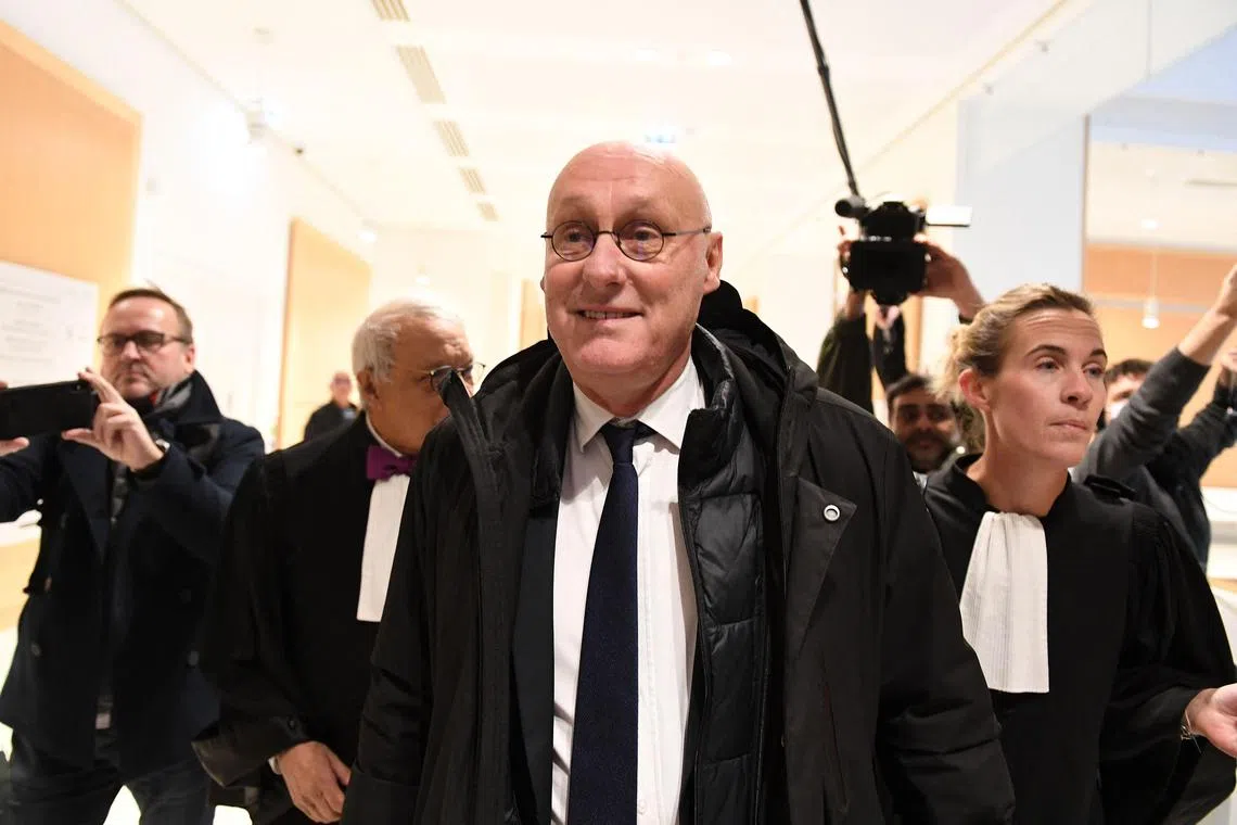 President of the French Rugby Federation  Bernard Laporte (centre), arrives at the correctional court in Paris on Tuesday to hear for its decision. - The decision is eagerly awaited, less than a year to go before the World Cup in France, whose organisational conditions are at the heart of a separate investigation opened in October, notably for corruption. (Photo by Alain JOCARD / AFP)