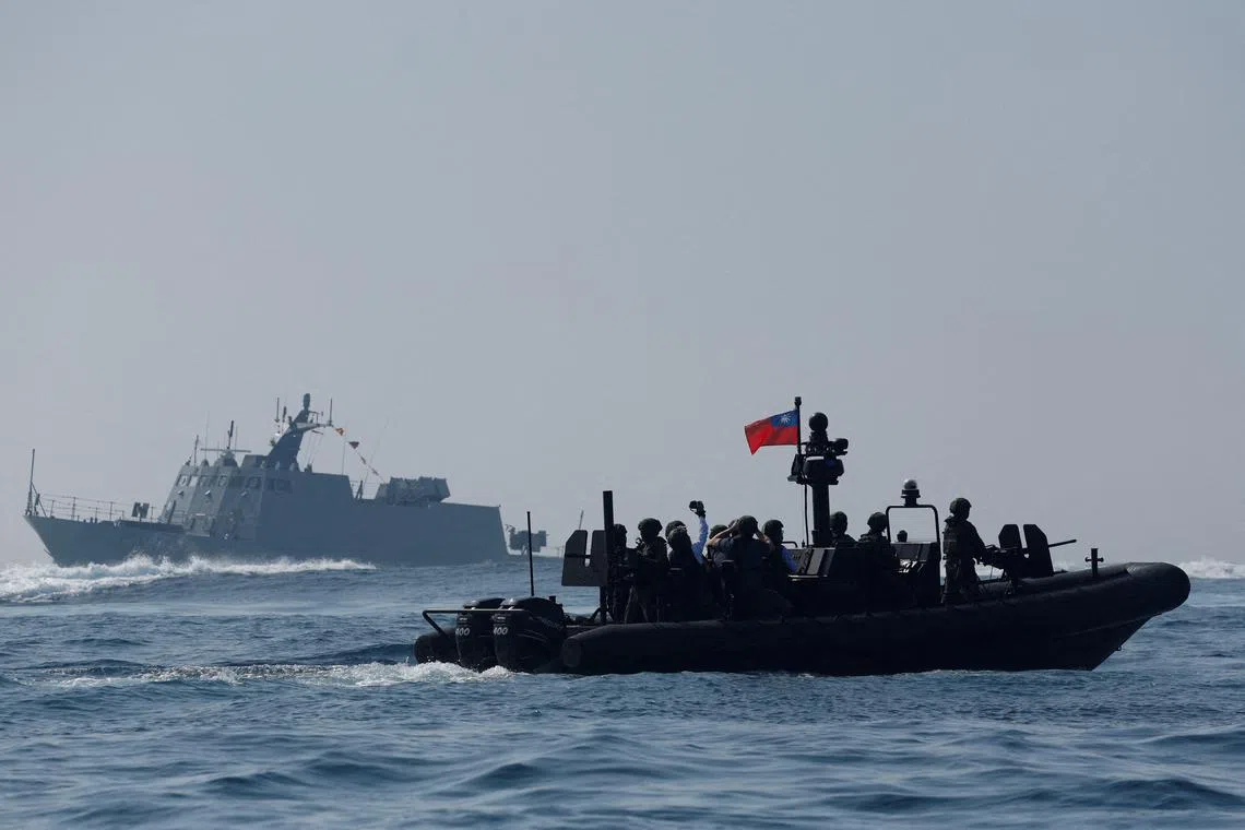 Members of Taiwan's Navy onboard a special operation boat navigate during a drill to show combat readiness in Kaohsiung, Taiwan, Jan 31.