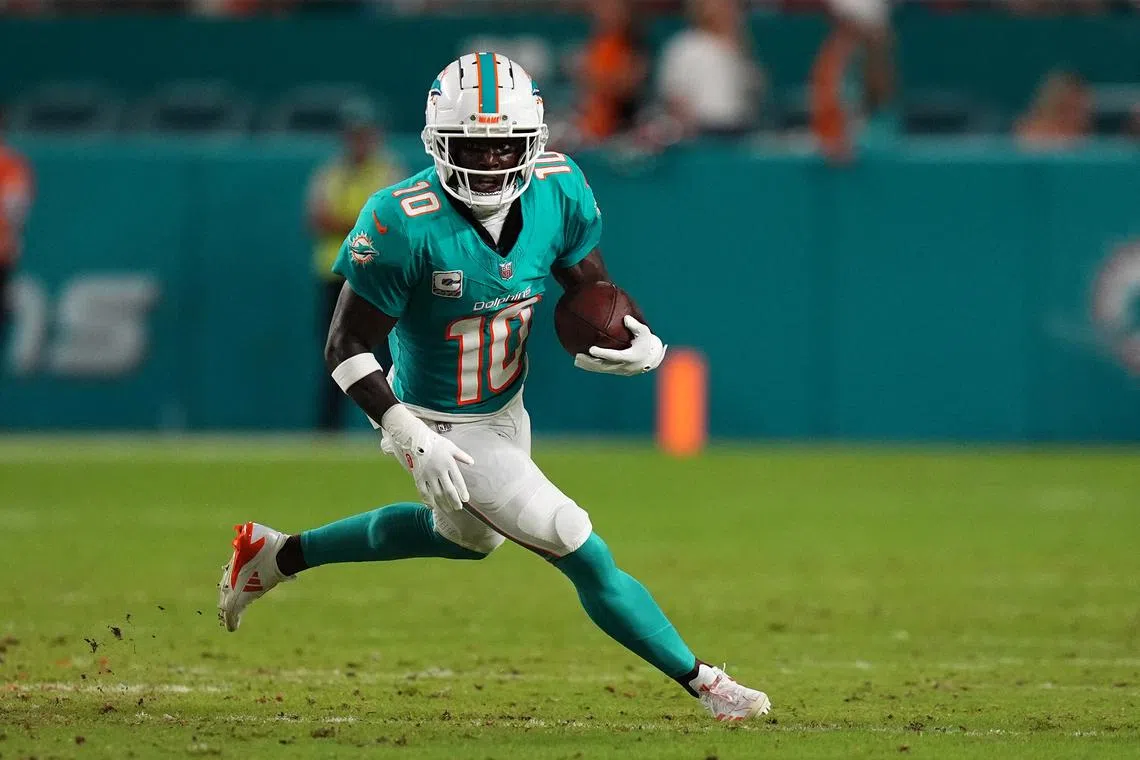 Sep 30, 2024; Miami Gardens, Florida, USA; Miami Dolphins wide receiver Tyreek Hill (10) runs with the ball during the first half against the Tennessee Titans at Hard Rock Stadium. Mandatory Credit: Jasen Vinlove-Imagn Images/File Photo