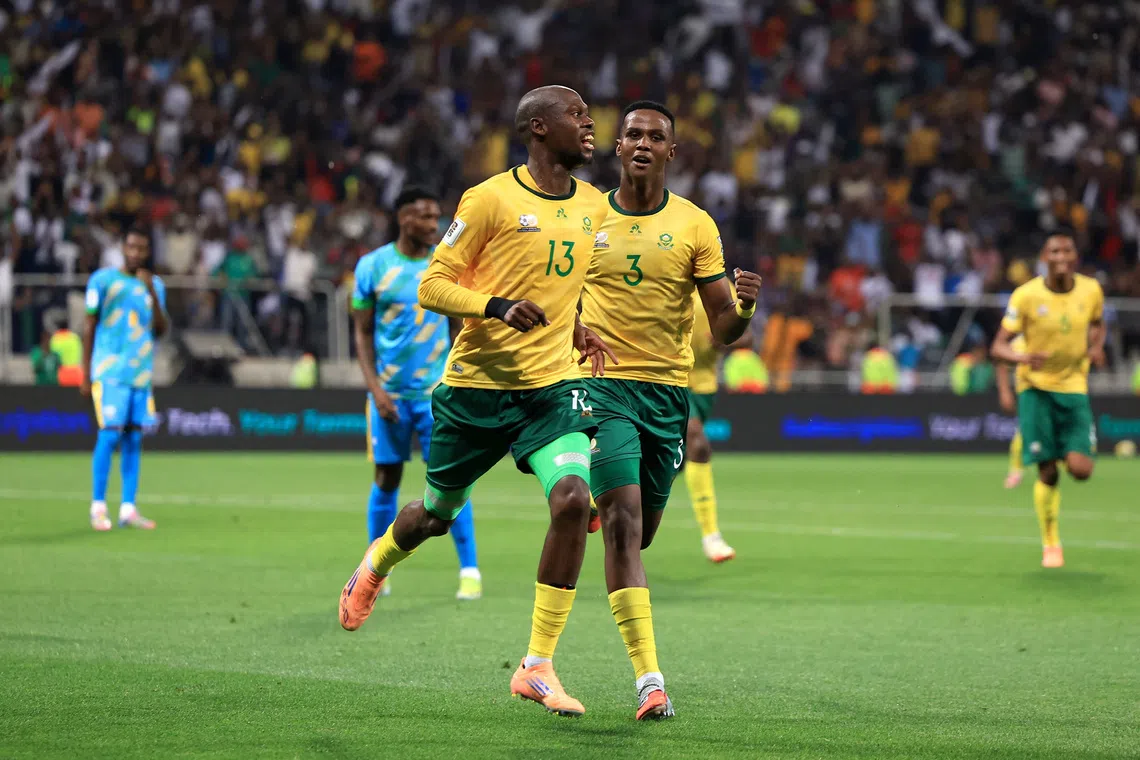 Soccer Football - FIFA World Cup - CAF Qualifiers - Group C - South Africa v Rwanda - Mbombela Stadium, Mbombela, South Africa - October 14, 2025 South Africa's Evidence Makgopa celebrates scoring their third goal with Khulumani Ndamane REUTERS/Esa Alexander