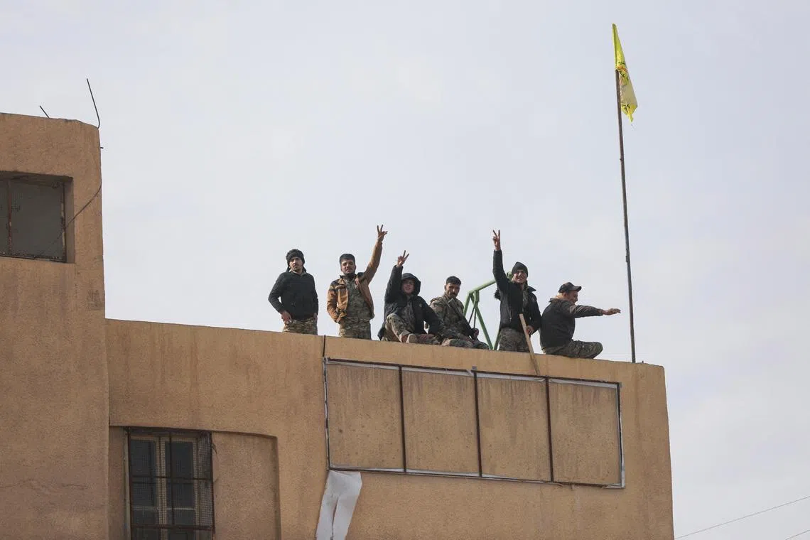 Members of the Kurdish-led Syrian Democratic Forces (SDF) gesture in Deir al-Zor, after U.S.-backed alliance led by Syrian Kurdish fighters captured Deir el-Zor, the government's main foothold in the vast desert, according to Syrian sources, in Syria December 7, 2024. REUTERS/Orhan Qereman/File Photo