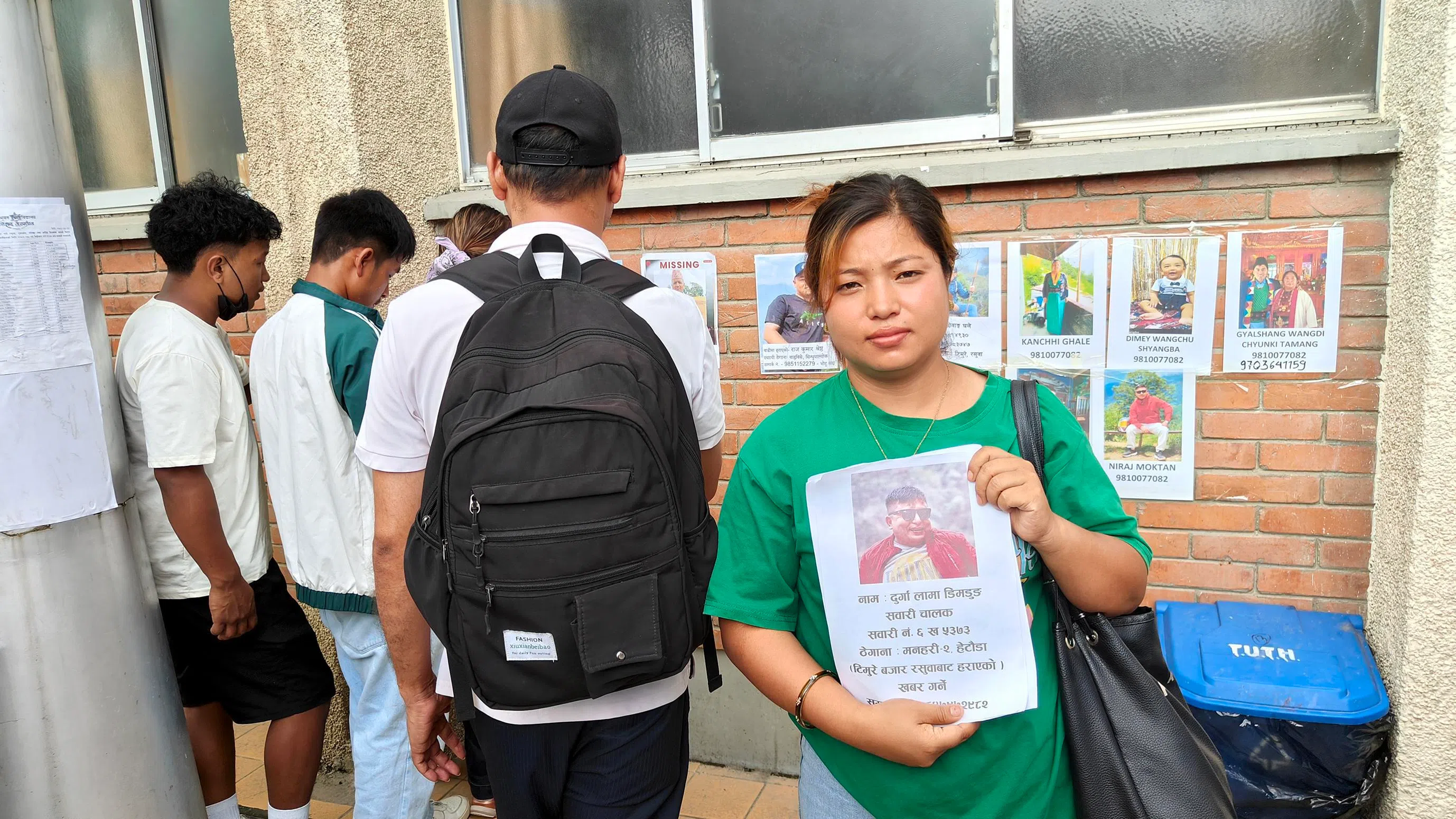 Rajina Lama holding a photo of her maternal uncle Durga Lama Dimdung who has been reported missing since Wednesday’s flash flood in northern Nepal.