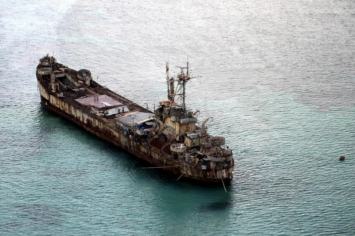 Filipino soldiers wave from the dilapidated Sierra Madre ship of the Philippine Navy as it is anchored near Ayungin shoal (Second Thomas Shoal) in the Spratly group of islands in the South China Sea, west of Palawan, Philippines, on May 11, 2015.  