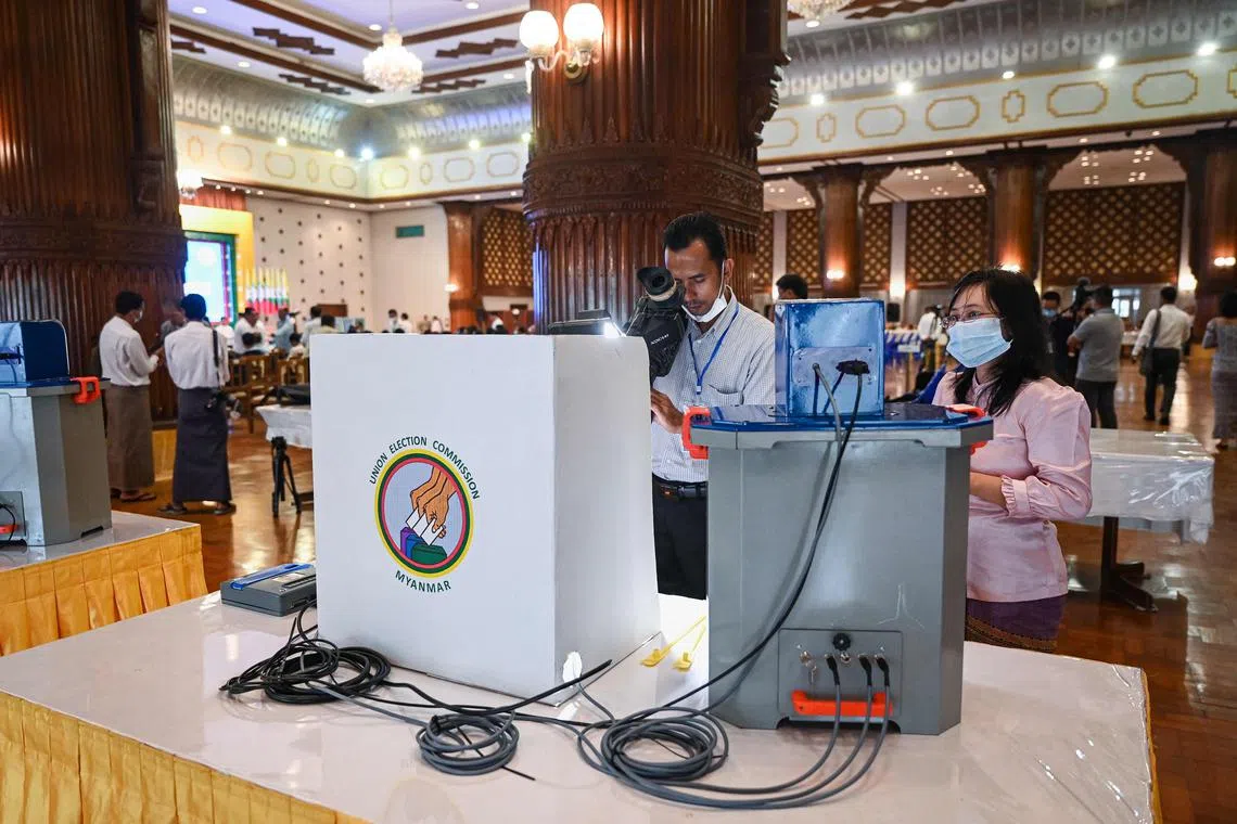 A journalist takes a video of a voting machine during a demonstration of voting machines to be used in future elections in Yangon on September 5, 2023. Myanmar's junta will likely hold elections in 2025, party officials told AFP on September 5, even as the military struggles to crush resistance to its rule. (Photo by AFP)
