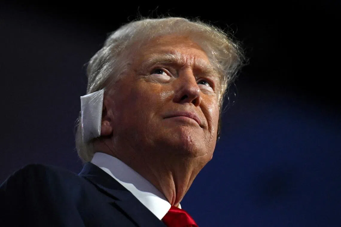 Republican presidential candidate and former President Donald Trump attends day 1 of the Republican National Convention on July 15, appearing with a bandaged ear.