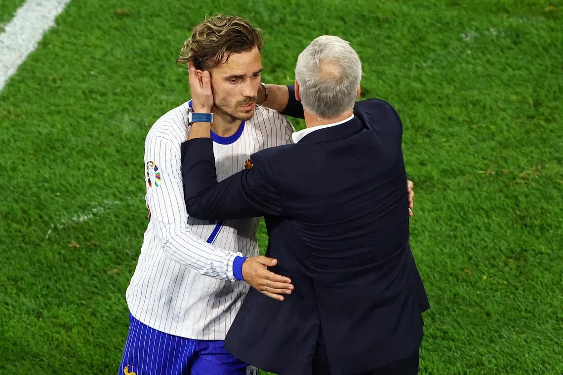 FILE PHOTO: Soccer Football - Euro 2024 - Group D - Austria v France - Dusseldorf Arena, Dusseldorf, Germany - June 17, 2024 France's Antoine Griezmann embraces coach Didier Deschamps after being substituted REUTERS/Bernadett Szabo/File Photo