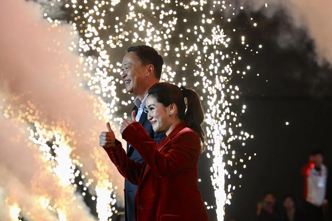 Pheu Thai party prime minister candidates Paethongtarn Shinawatra (foreground) and Srettha Thavisin greeting the crowd at a rally in Nonthaburi, Bangkok, on May 12, 2023. 