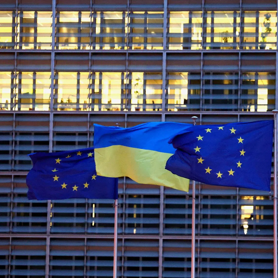 European Union flags and a Ukrainian flag flutter outside the EU Commission headquarters in Brussels, Belgium, February 24, 2025. REUTERS/Yves Herman