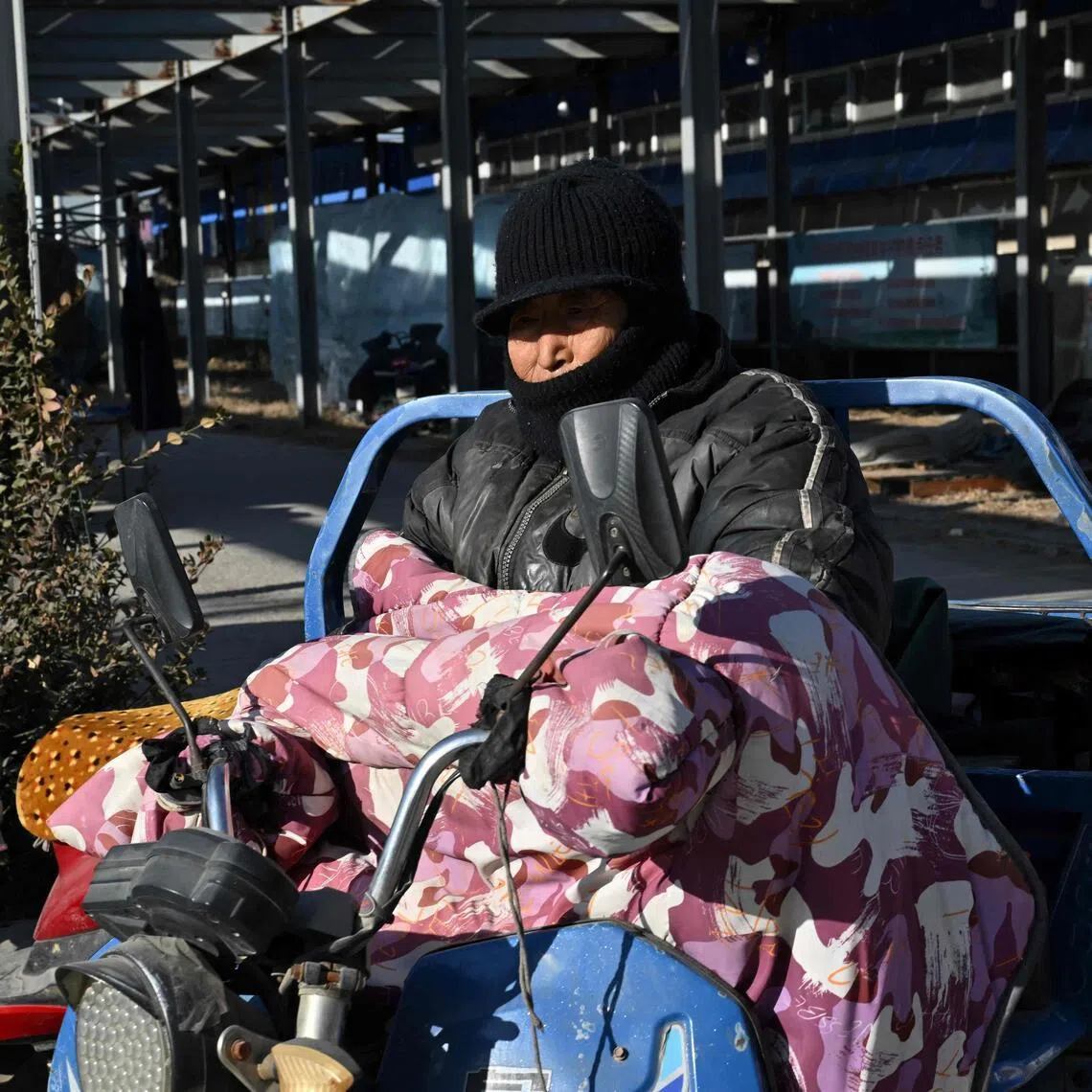 A motorist rides through a neighbourhood affected by the heating subsidy policy in Baoding city, northern China's Hebei province on Jan 7, 2026.
