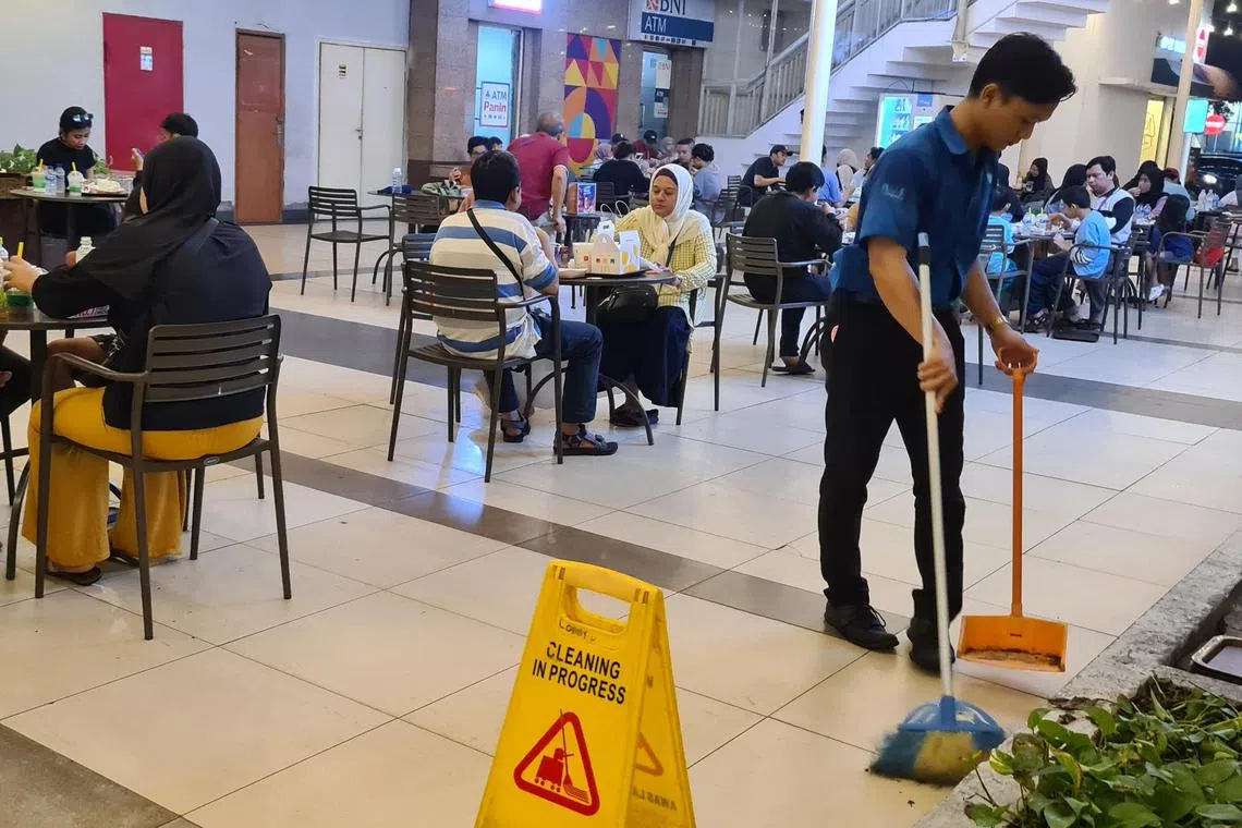 A young cleaning worker at a shopping mall in South Tangerang in Indonesia's Banten province. 