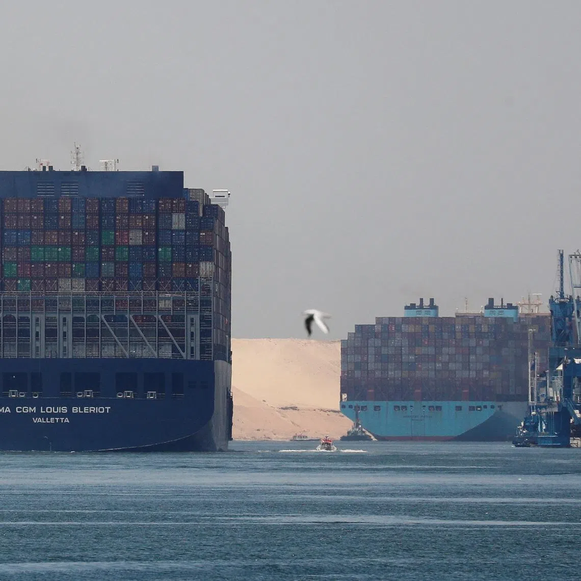 CMA CGM Louis Bleriot and a Maersk Line container ship pass through the Suez Canal in Ismailia, Egypt July 7, 2021. Picture taken July 7, 2021. REUTERS/Amr Abdallah Dalsh