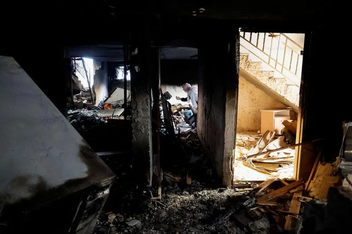 A Palestinian woman checks the damage after an Israeli raid, in Jenin refugee camp in the Israeli-occupied West Bank, November 3, 2023. REUTERS/Raneen Sawafta