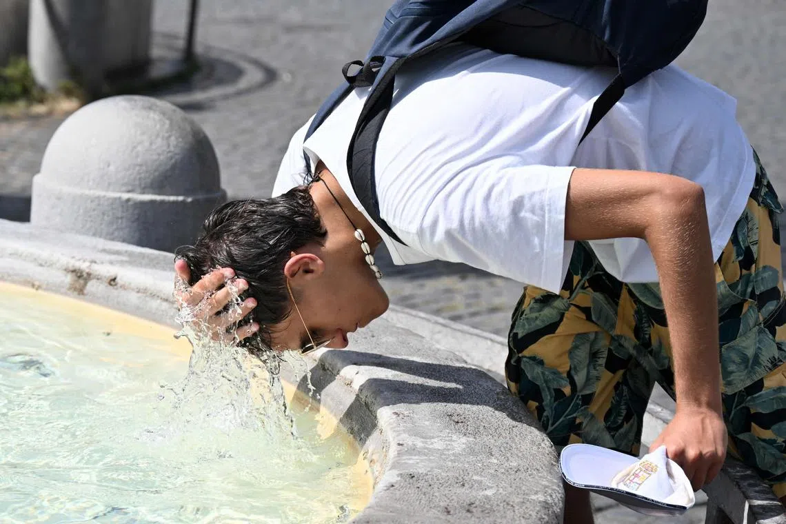 A boy cools off at a fountain in Rome, as baking temperatures hit Europe during the peak summer tourist season.