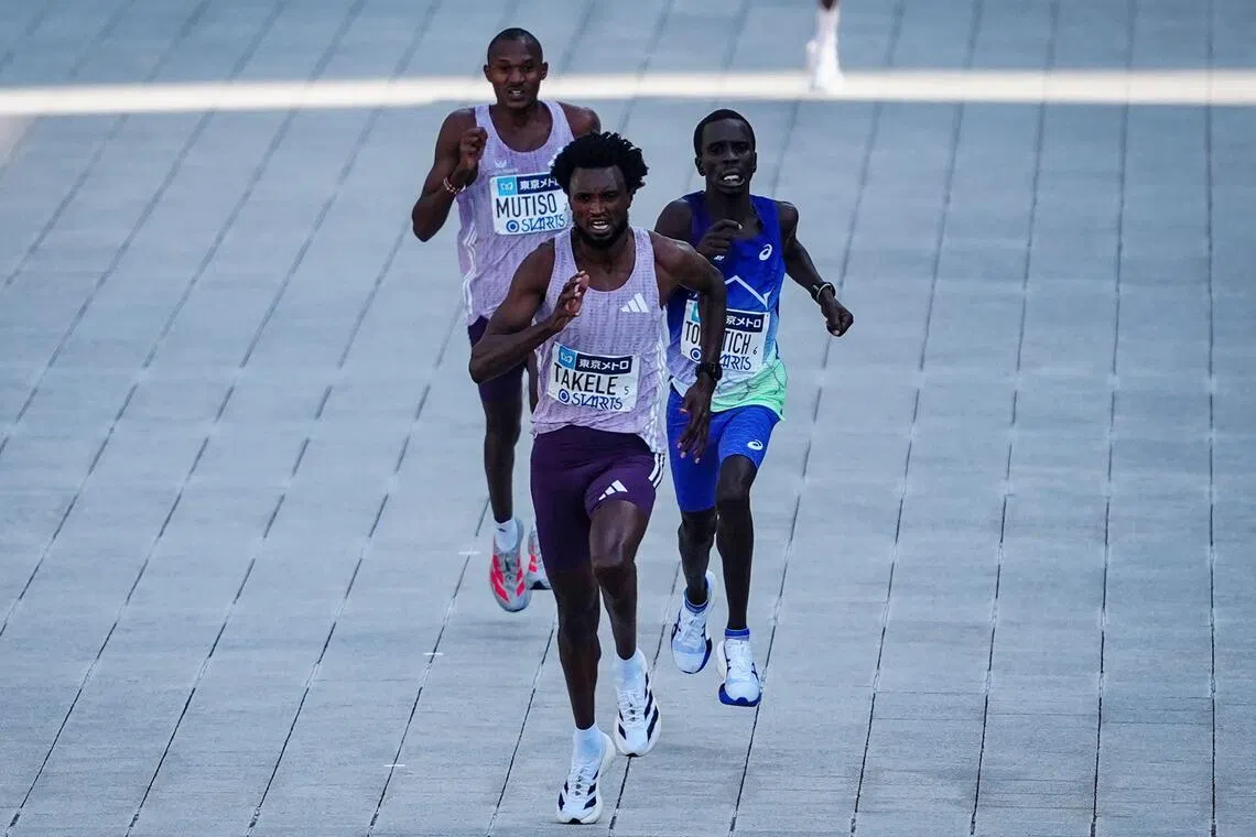 Ethiopia’s Tadese Takele races to the finish line first followed by Kenya’s Geoffrey Toroitich (middle) and Kenya’s Alexander Mutiso (back) in the men's category of the Tokyo Marathon.