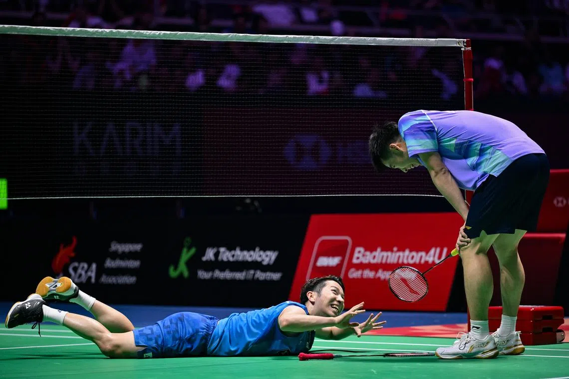 Koki Watanabe (left) and Loh Kean Yew speaking during their men’s singles semi-final at the Singapore Open on May 30.