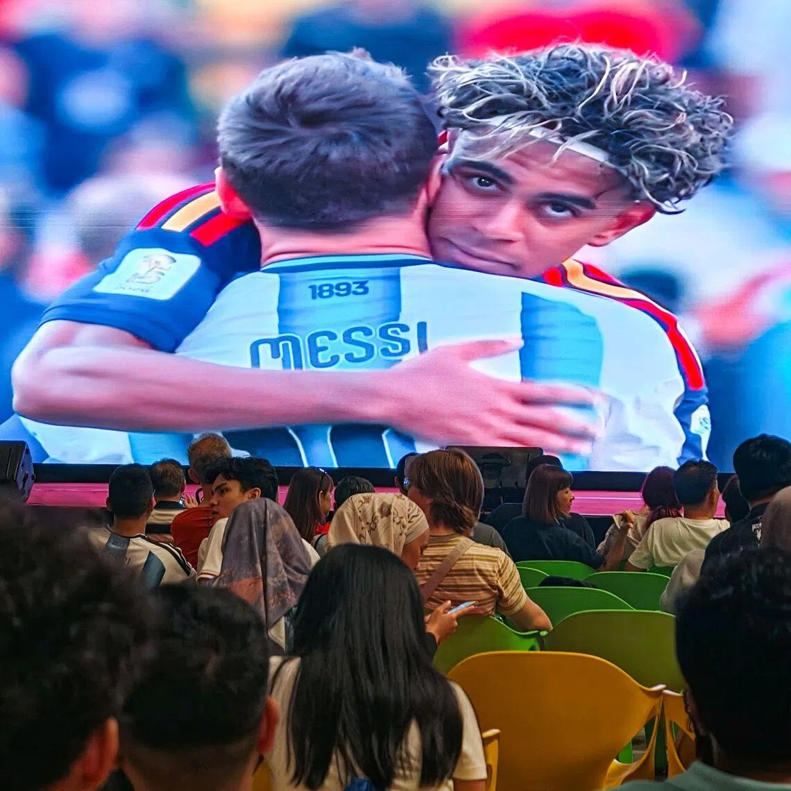 Fans watching Spanish winger Lamine Yamal hugging Argentina's Lionel Messi after the FIFA World Cup 2026 final between Argentina and Spain at Our Tampines Hub in the early hours of July 20, 2026. ST PHOTO: BRIAN TEO
