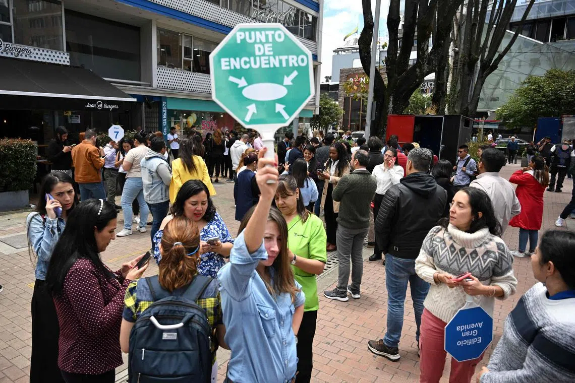 People remain on the streets after an eartquake in Bogota.