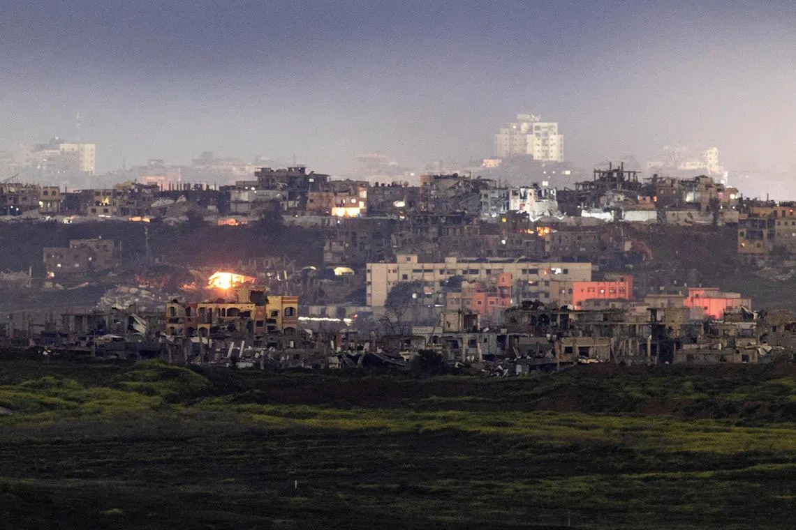 Fire burns in damaged houses, amid a ceasefire between Hamas and Israel, as seen from the Israeli side of the border, on Feb 24, 2025.