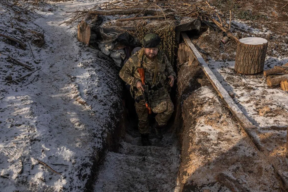 A Ukrainian soldier of the 41st brigade walks near the frontline outside Kupiansk in Ukraine's Kharkiv region.