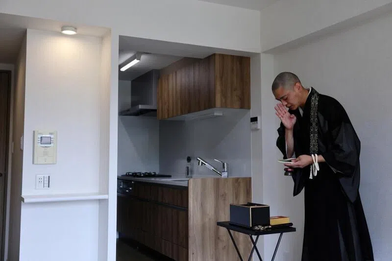 A Buddhist monk performing a ceremony for lost souls at a property which is classified as a “jiko bukken”, or “misfortunate property”, in Kawasaki, Japan.
