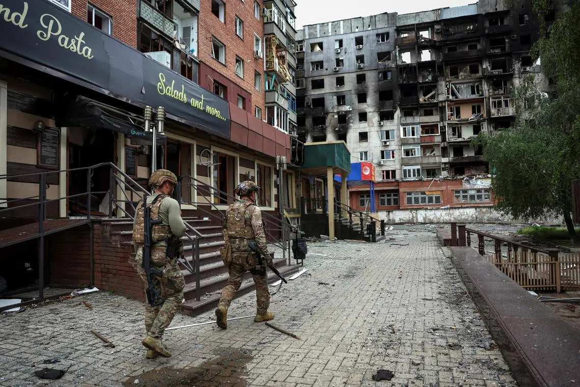 A May 2025 photo shows Ukrainian officials who evacuate people from front-line towns and villages in Pokrovsk, in Ukraine's Donetsk region.