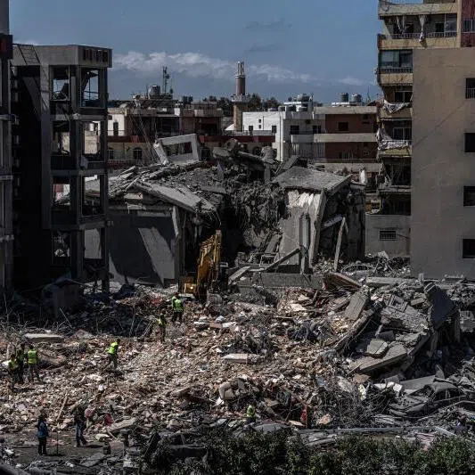 Rescue workers use an excavator as they search for people on June 2, 2026, under the rubble of a building that was hit in an Israeli strike in the southern port city of Tyre.