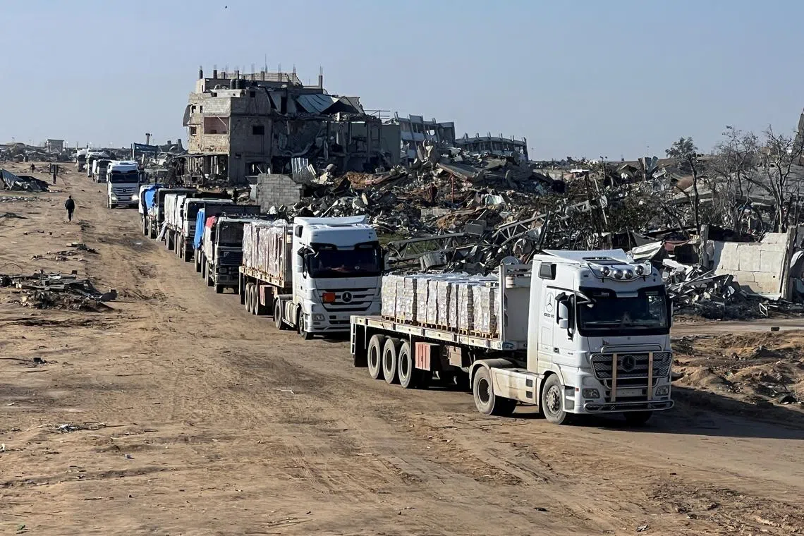 Trucks carrying aid move, amid a ceasefire between Israel and Hamas, in Rafah in the southern Gaza Strip, February 13, 2025. REUTERS/Hussam Al-Masri/File Photo
