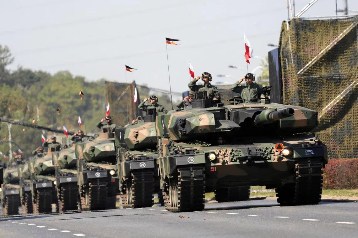 Polish soldiers on Leopard 2PL tanks taking part in a military parade on Polish Armed Forces Day in August.