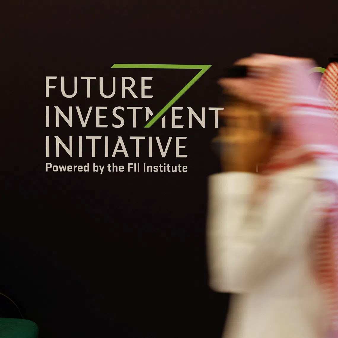 Delegates walk at the venue of the Future Investment Initiative (FII) in Riyadh, Saudi Arabia Oct 29, 2024.