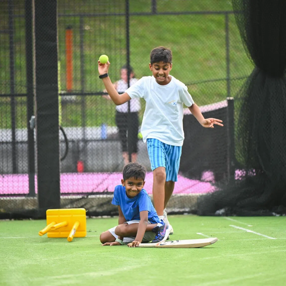 Brothers Jay (in blue shirt), seven, and Neel Ramnarayan, ten, launched a Migrant Worker Premier League which kicked off in May.