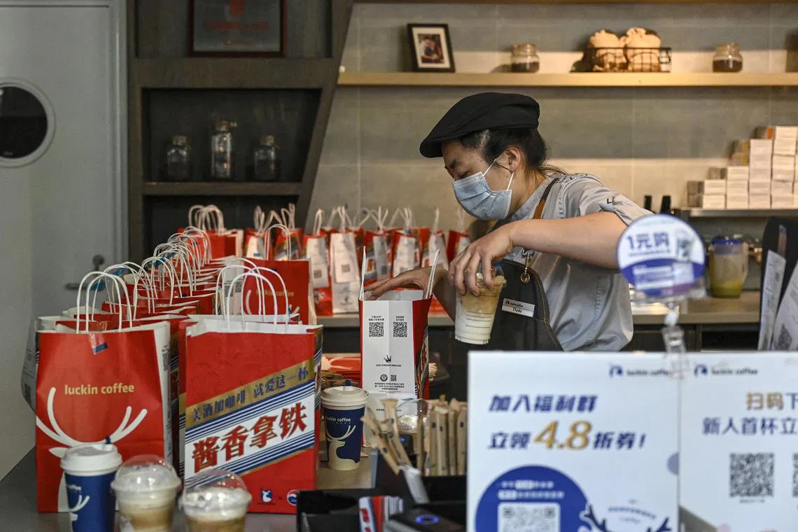 A Luckin Coffee worker packing baijiu-flavoured latte, a drink in collaboration with Chinese liquor brand Kweichow Moutai, at a Beijing outlet.